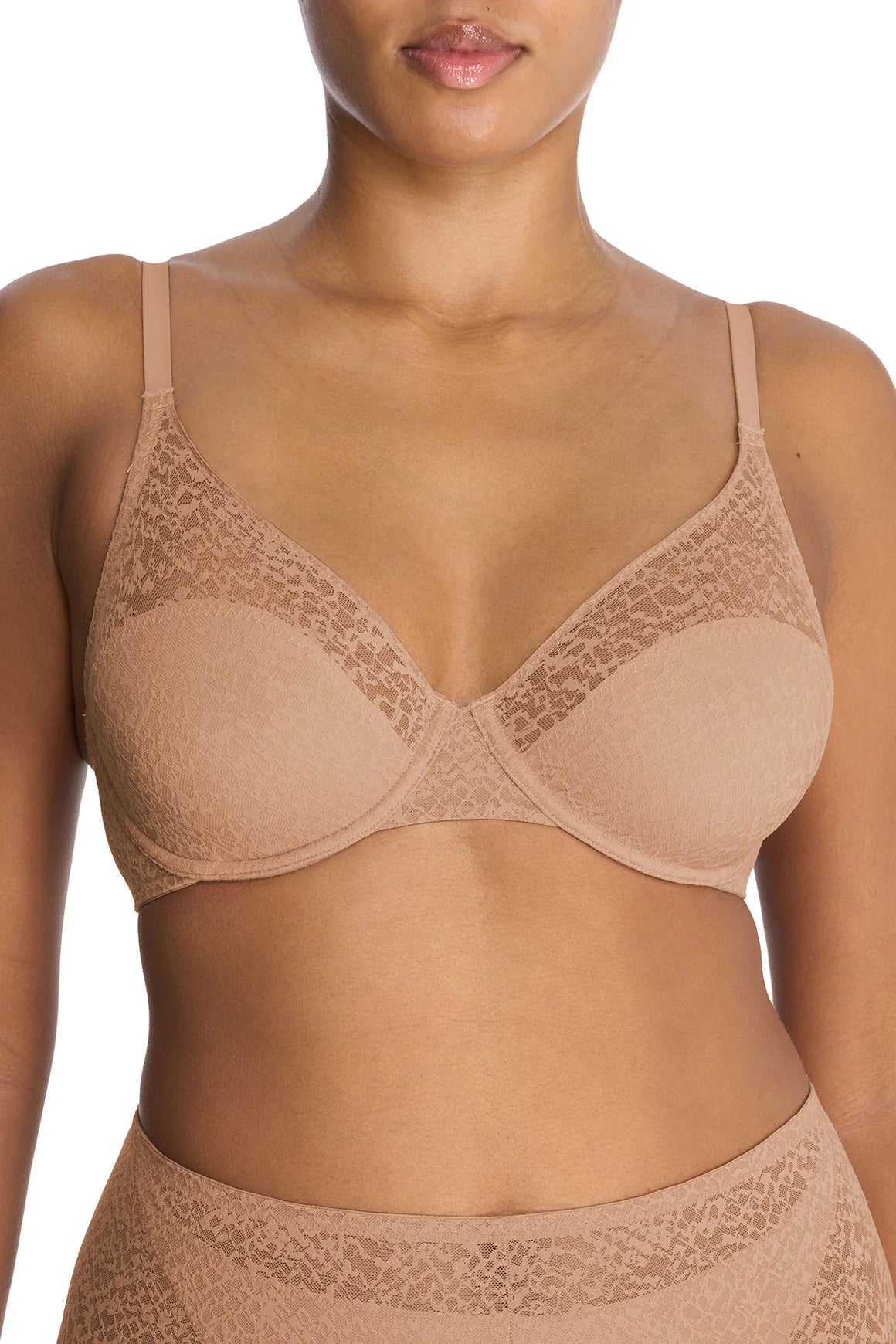 The Natori Pretty Smooth Underwire Bra in Buff, displayed on a model, features a sleek, seamless design with lightly padded cups for a smooth, invisible fit under clothing. The adjustable straps and underwire support provide a natural lift, making it a comfortable everyday essential.