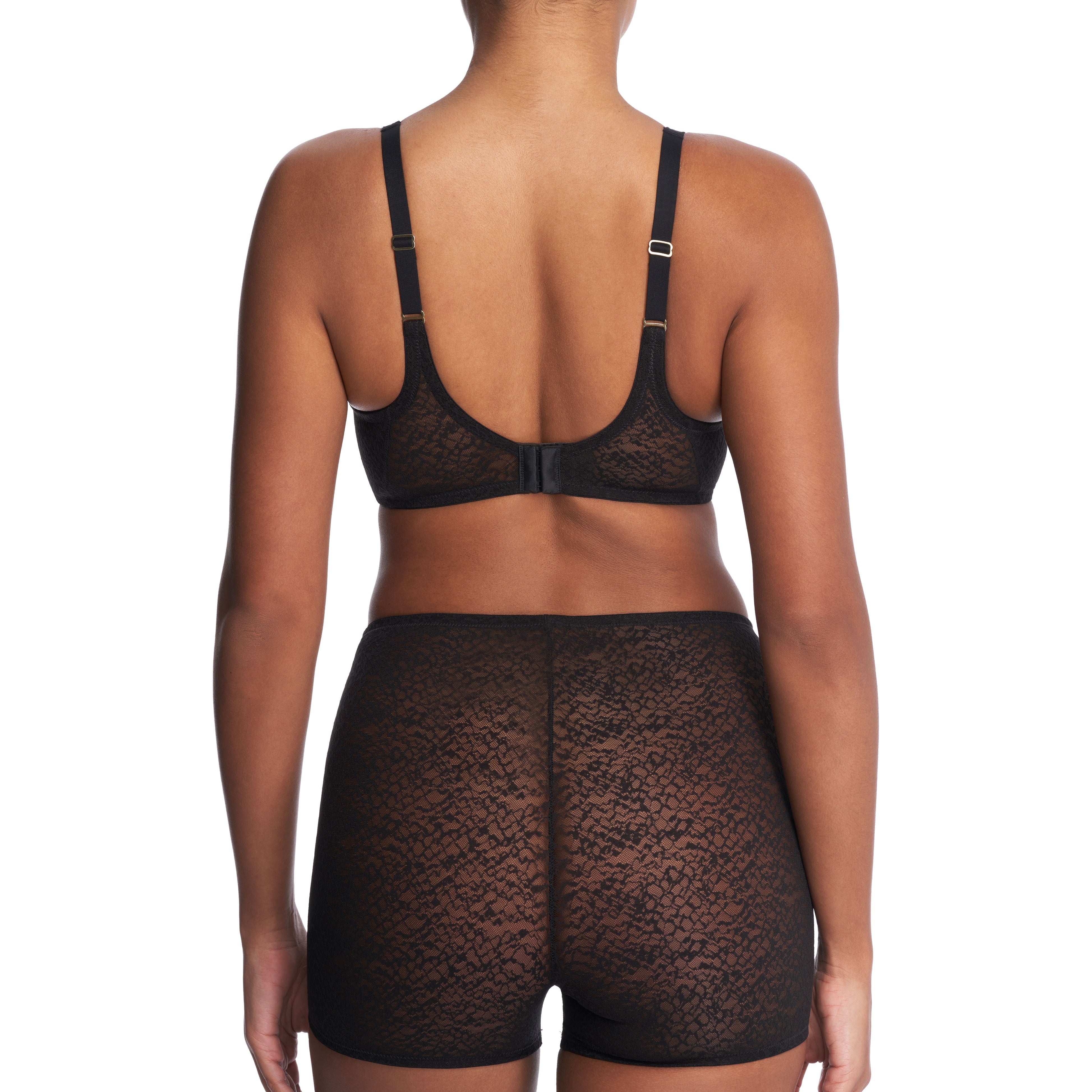 Model wearing a black lace full-coverage underwire bra with matching smoothing shortlette, shown from the back.